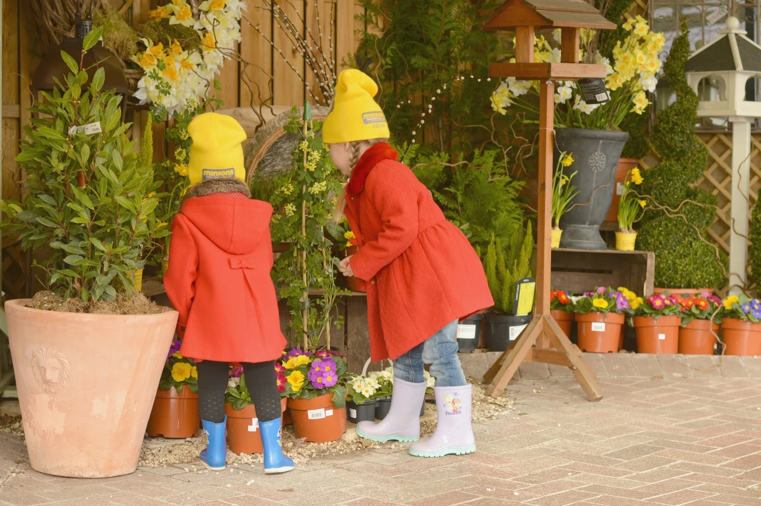 Girls sniffing flowers