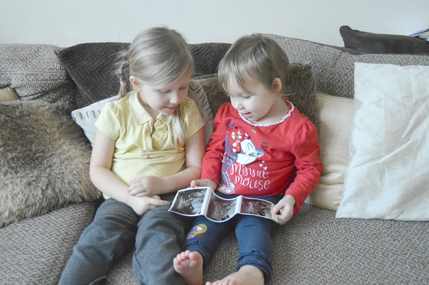 Sisters with baby scan