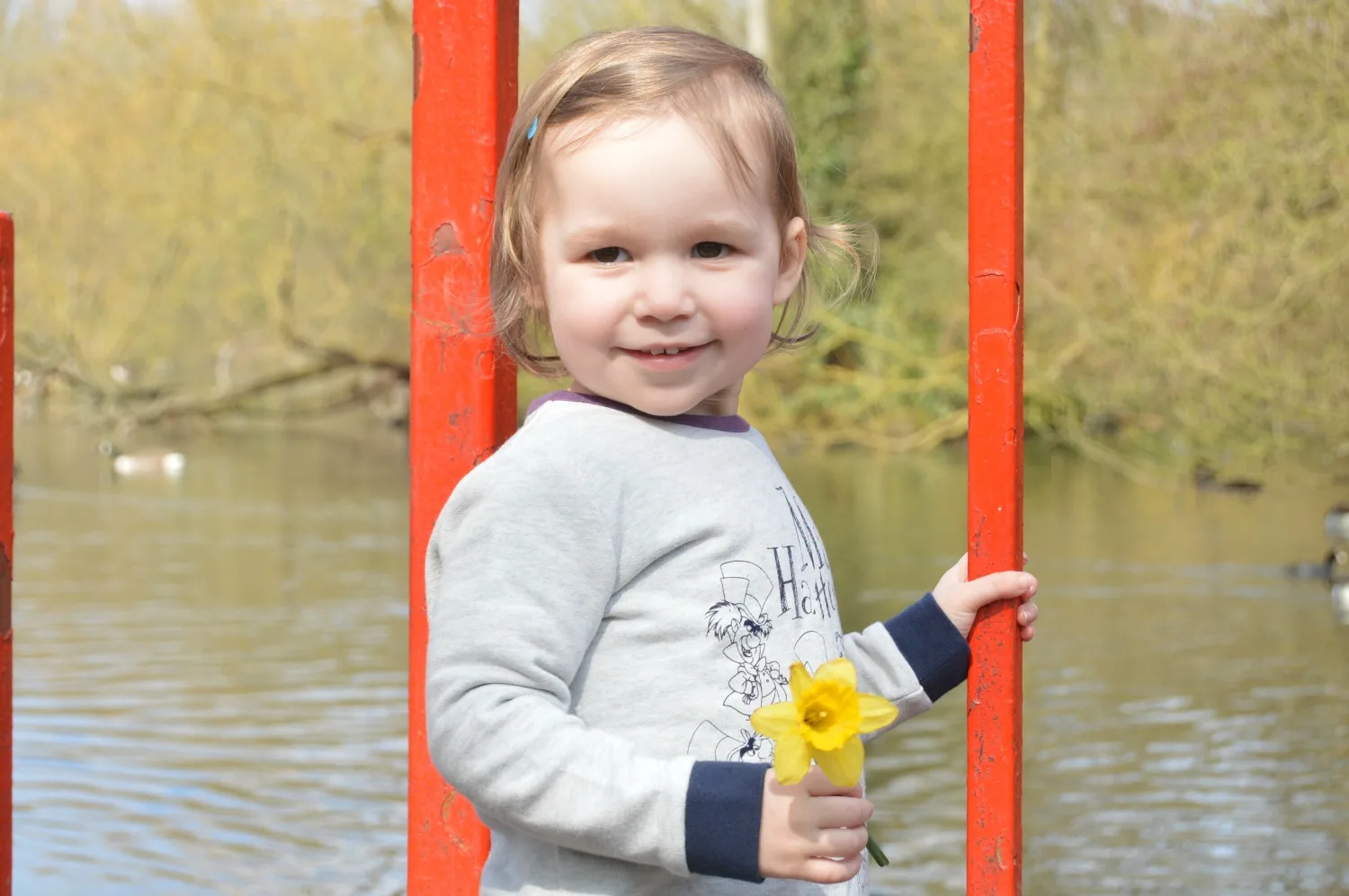 LJ smiling with a daffodil