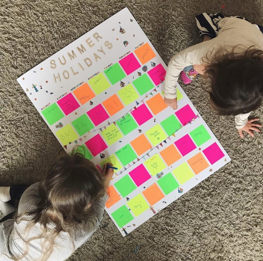birdseye view of children filling in a planner