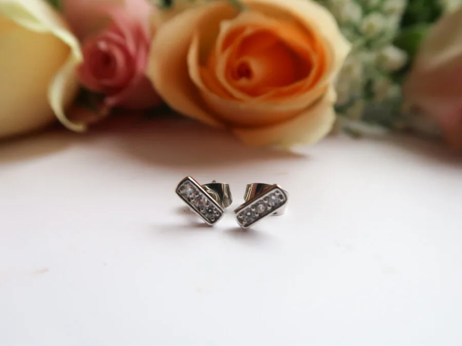 earrings next to flowers