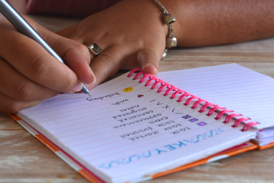 someone doing bullet journalling in notebook