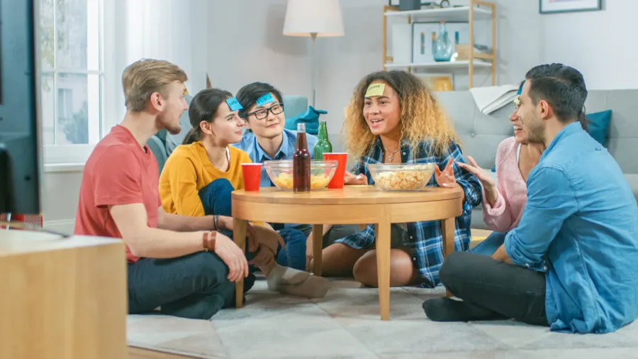 family playing sticky notes on forehead