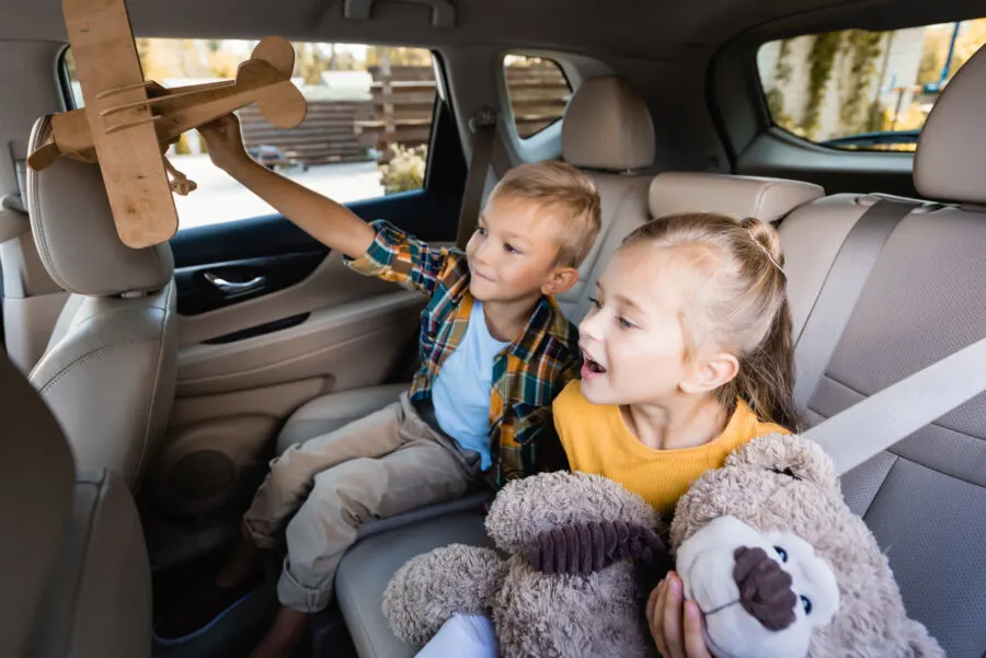boy and a girl in the back of car