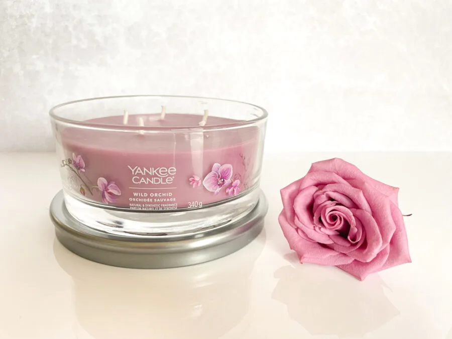 Yankee Candle next to a rose
