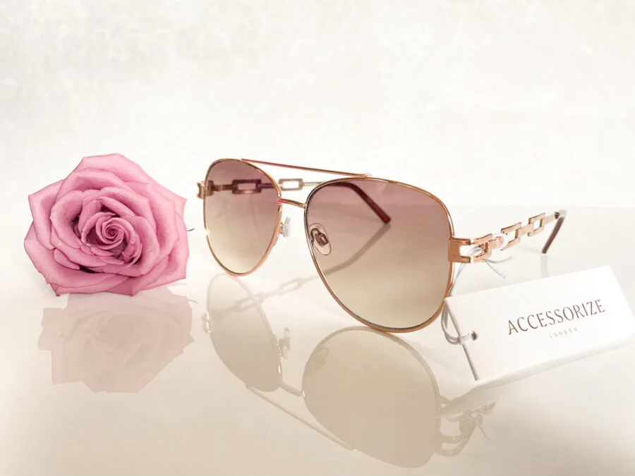 Accessorize Sunglasses next to a rose