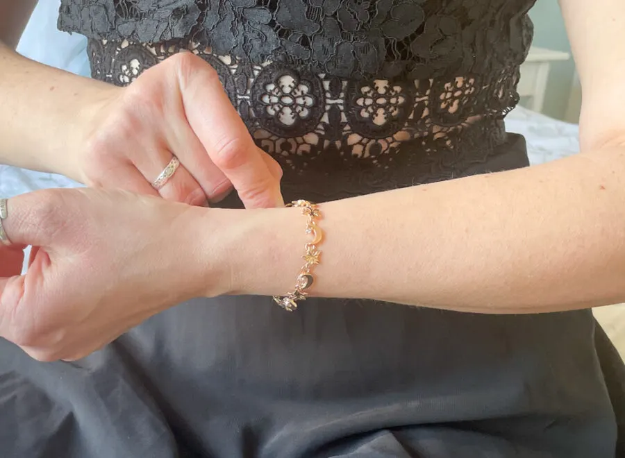 woman putting on bracelet