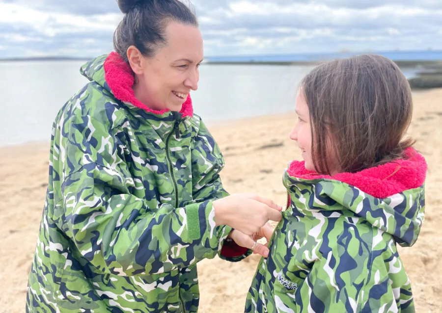 mum zipping up daughter coat