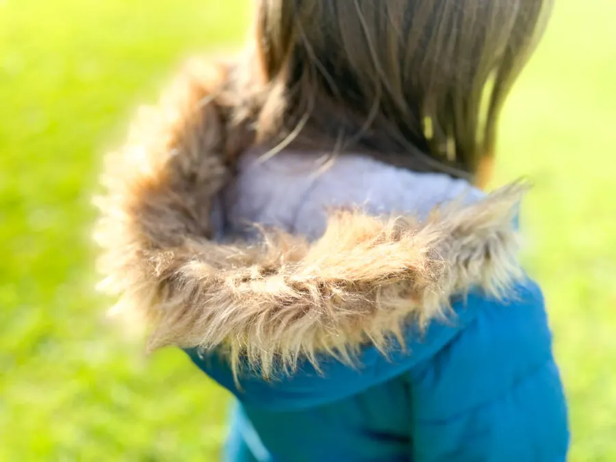 Girl wearing Lands' End fleece lined coat with fluffy hood
