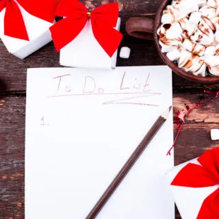 Christmas To Do List. Cup of hot cocoa or chocolate with marshmallow on wooden background. Flat lay. Christmas planning concept.