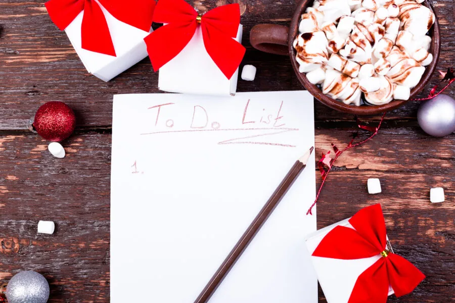 Christmas To Do List. Cup of hot cocoa or chocolate with marshmallow on wooden background. Flat lay. Christmas planning concept.