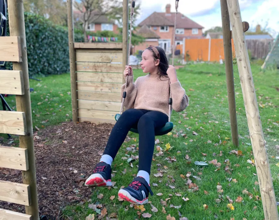Girl swinging on the swing set