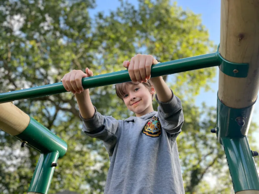 Boy on monkey bars