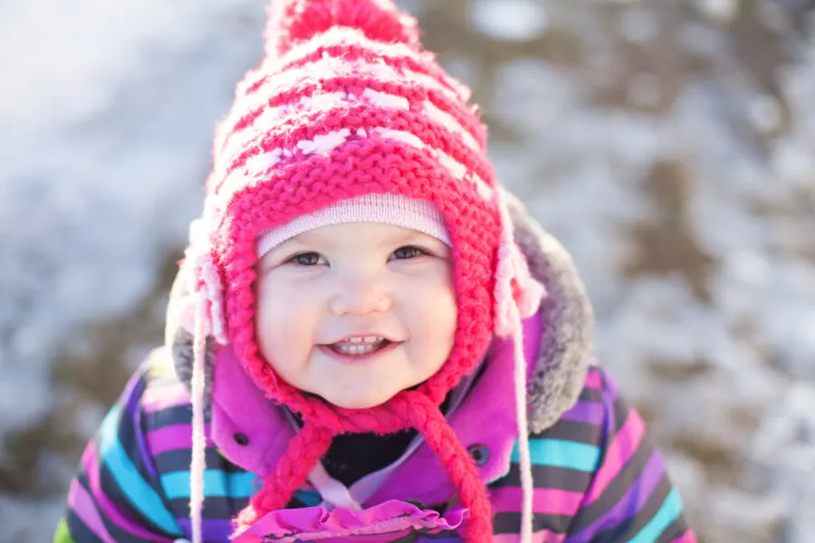 little baby portrait, winter day, snow on a background